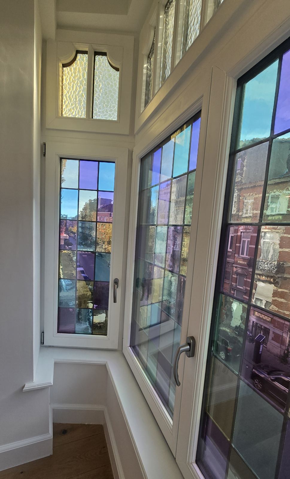 Oriel with original coloured stained glass seen from inside